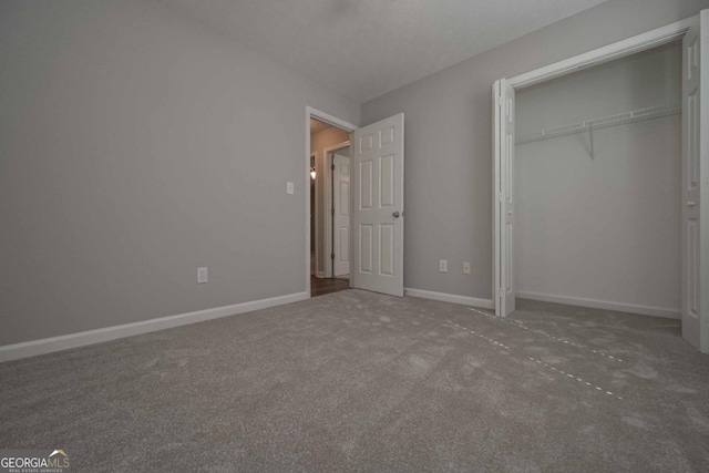 unfurnished bedroom with a closet and carpet