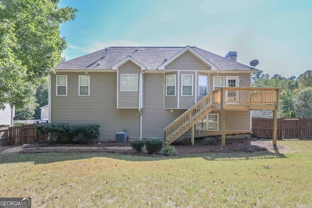 back of property with central AC, a deck, and a lawn