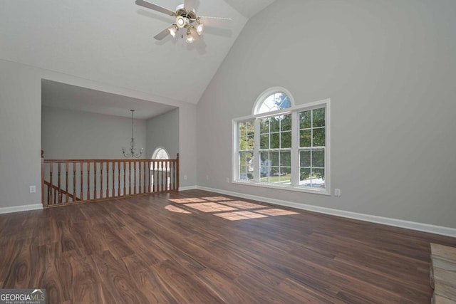 interior space featuring dark hardwood / wood-style floors, high vaulted ceiling, and ceiling fan with notable chandelier