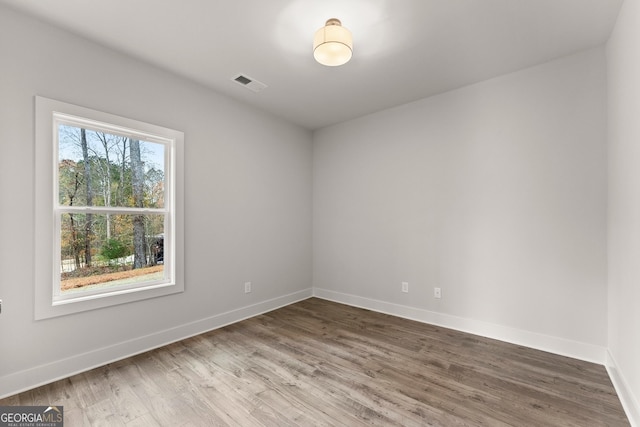 unfurnished room with wood-type flooring