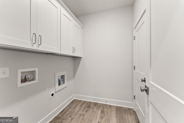 clothes washing area featuring hookup for an electric dryer, hookup for a washing machine, light hardwood / wood-style flooring, and cabinets