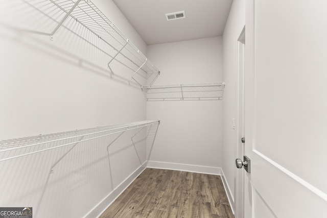 spacious closet featuring hardwood / wood-style flooring