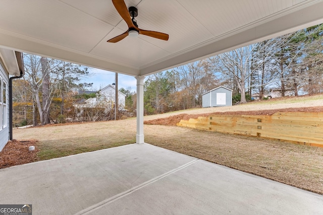 view of patio with ceiling fan and a storage shed