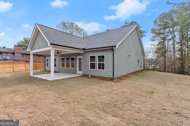 rear view of property with a lawn and a patio