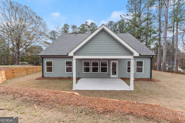 rear view of house with a patio area and a yard