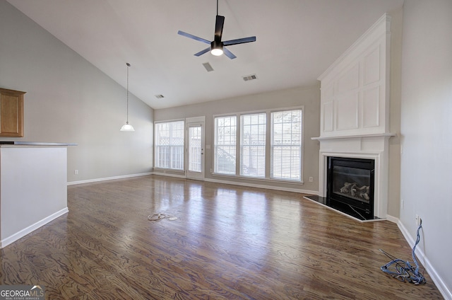 unfurnished living room featuring dark hardwood / wood-style flooring, high vaulted ceiling, and ceiling fan