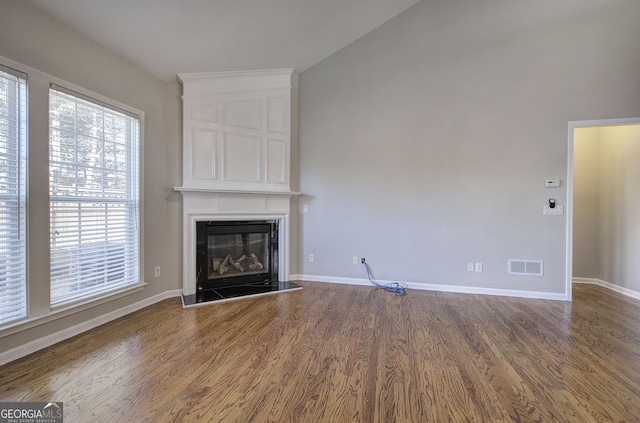 unfurnished living room with a fireplace and hardwood / wood-style flooring