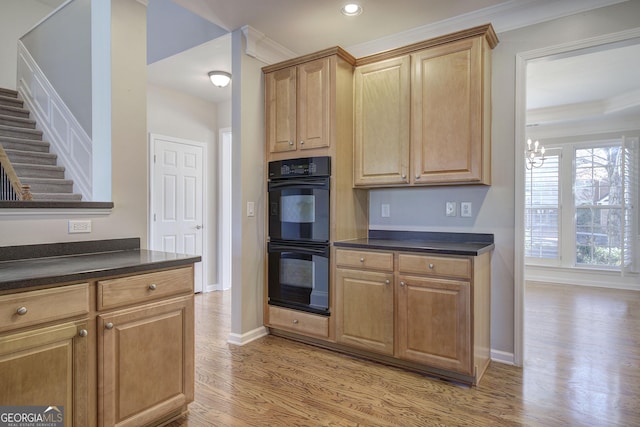 kitchen featuring a chandelier, light wood-type flooring, double oven, and ornamental molding