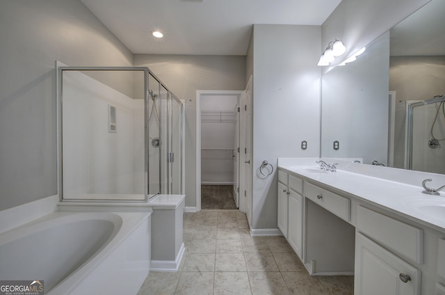 bathroom with tile patterned flooring, vanity, and shower with separate bathtub