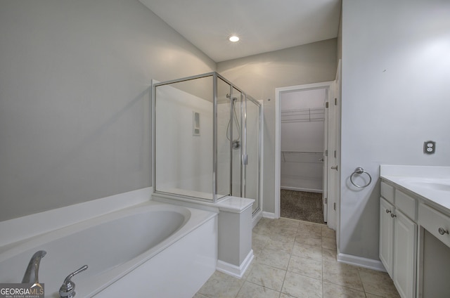 bathroom featuring vanity and independent shower and bath