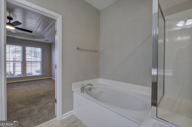 bathroom with separate shower and tub, a raised ceiling, ceiling fan, and ornamental molding