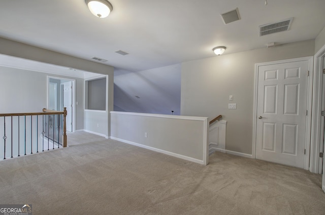 hallway featuring light carpet