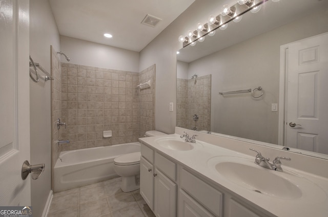 full bathroom featuring tile patterned floors, vanity, toilet, and tiled shower / bath