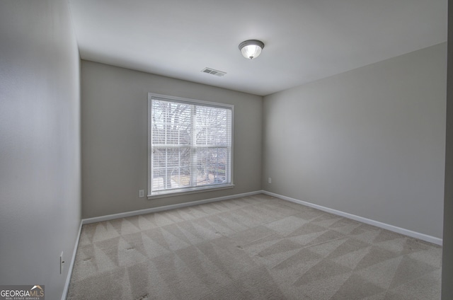 empty room featuring light colored carpet