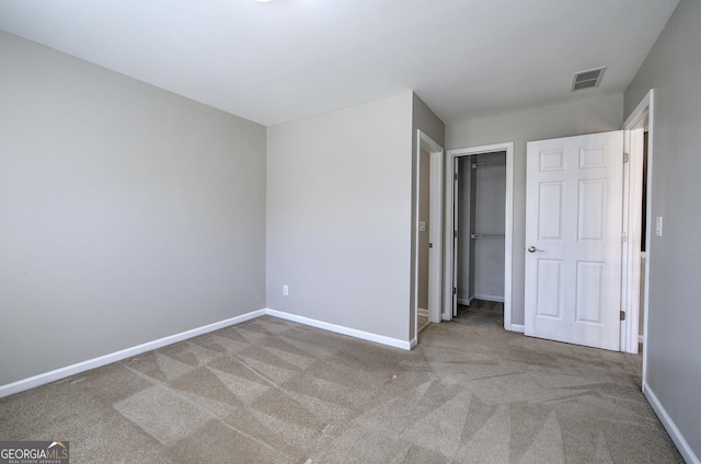 unfurnished bedroom featuring carpet flooring and a closet