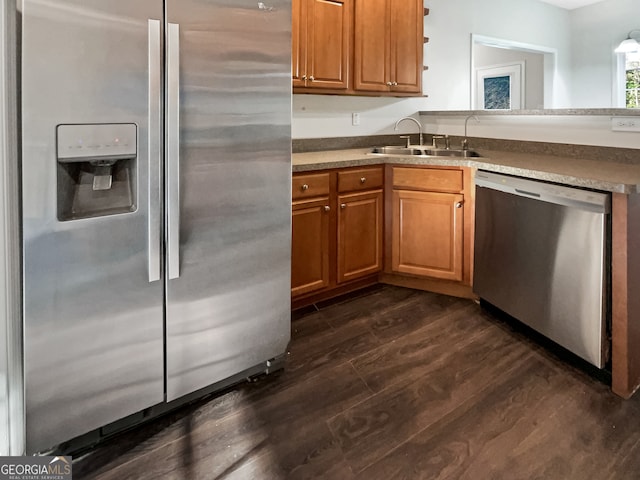 kitchen featuring sink, stainless steel appliances, and dark hardwood / wood-style flooring