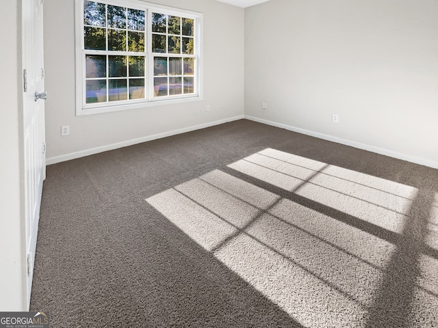 empty room with dark colored carpet