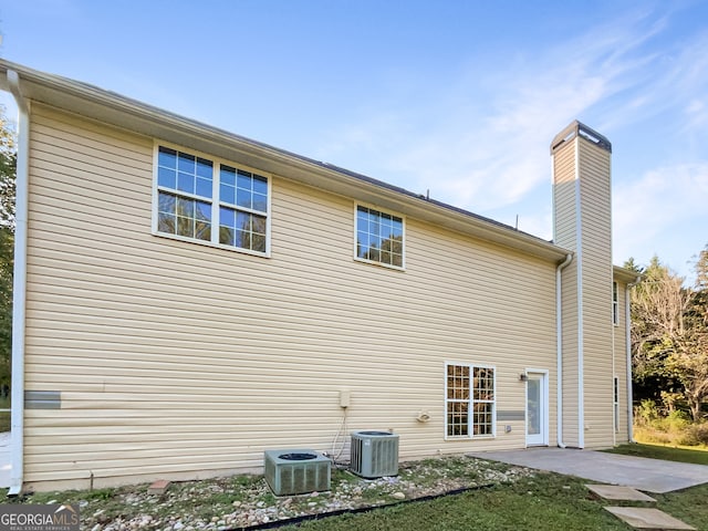 view of side of property featuring a patio area and central AC unit