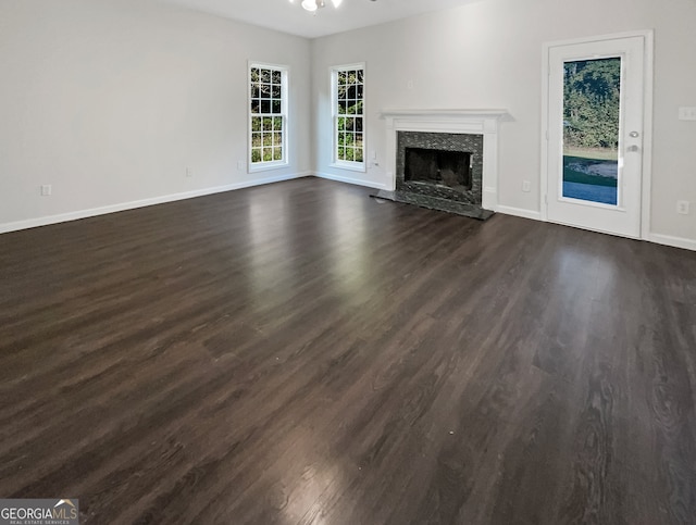 unfurnished living room featuring ceiling fan and dark hardwood / wood-style floors