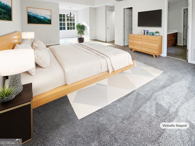 carpeted bedroom featuring a chandelier and ensuite bathroom