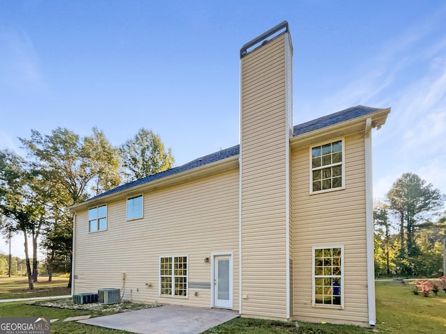 back of house featuring a patio, a lawn, and central air condition unit