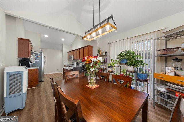 dining room with lofted ceiling and dark hardwood / wood-style flooring