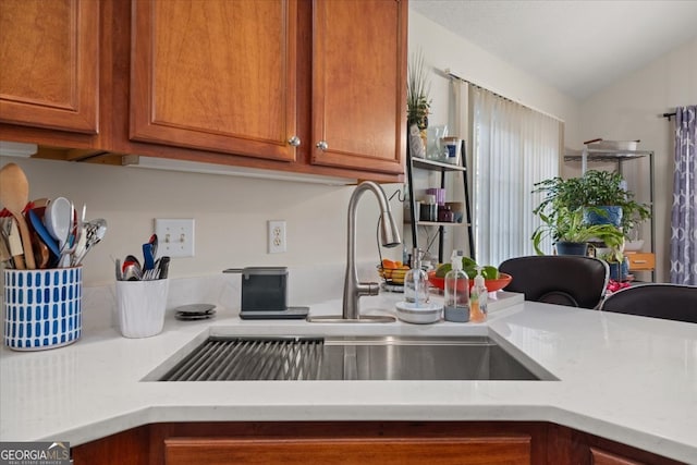 kitchen featuring sink and vaulted ceiling