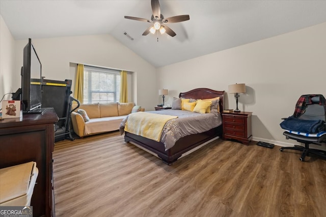 bedroom with wood-type flooring, vaulted ceiling, and ceiling fan