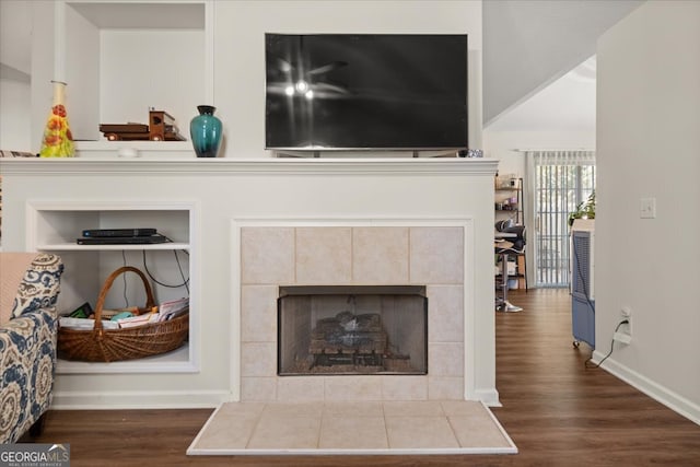 interior details with a fireplace, hardwood / wood-style flooring, and built in features