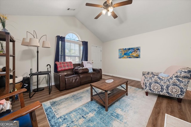 living room with ceiling fan, hardwood / wood-style flooring, and vaulted ceiling