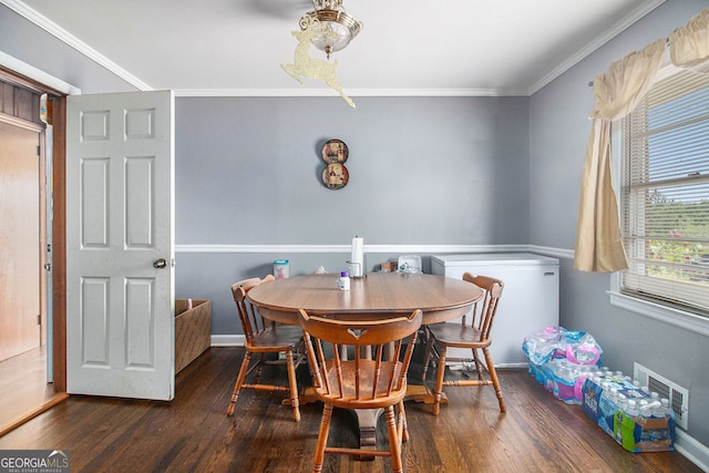 dining room with crown molding and dark hardwood / wood-style floors