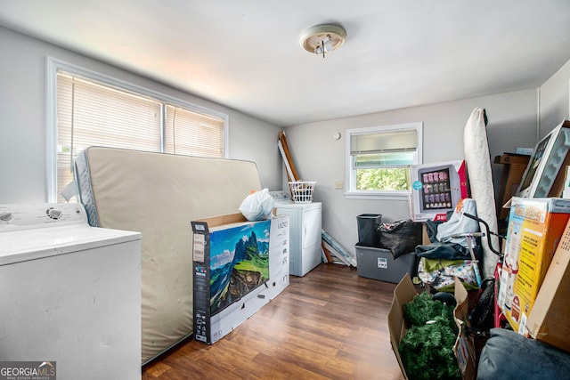 clothes washing area featuring washing machine and clothes dryer and dark hardwood / wood-style flooring