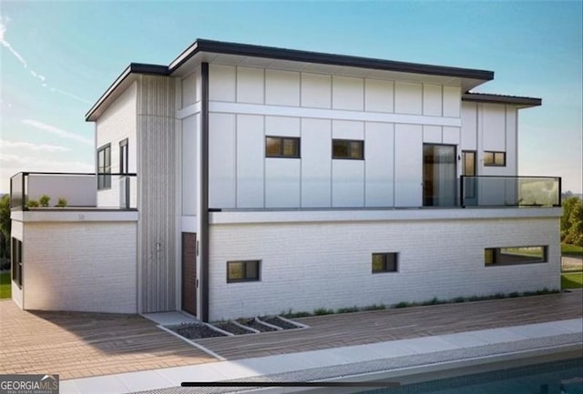 view of side of home with a balcony and a swimming pool