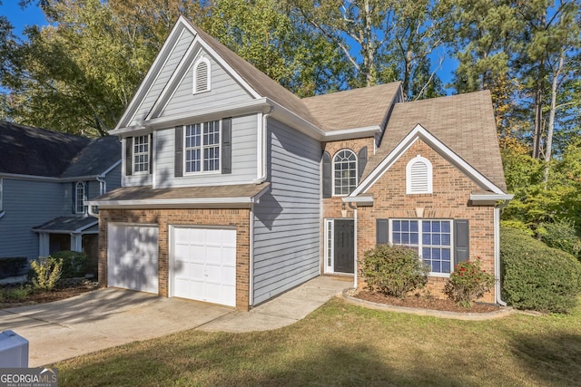 view of property featuring a front yard and a garage