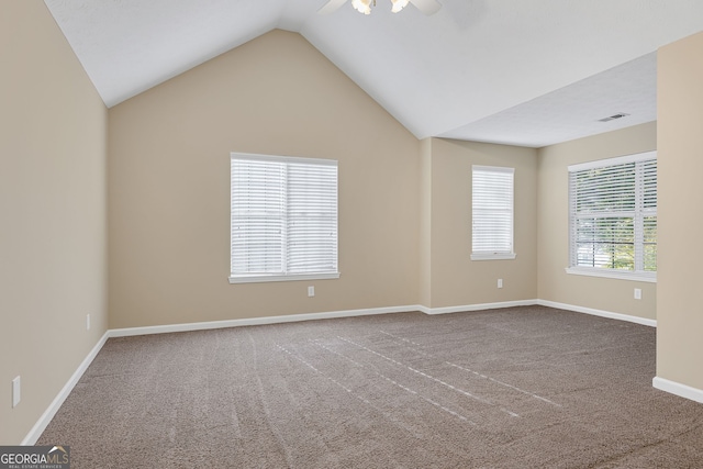 spare room featuring ceiling fan, vaulted ceiling, and carpet floors