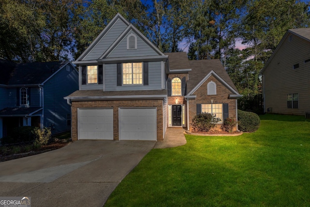 view of property with a garage and a lawn