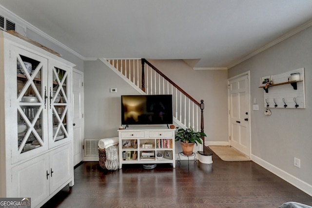 entryway featuring crown molding and dark hardwood / wood-style flooring