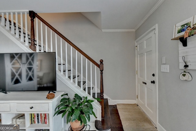 entrance foyer with ornamental molding and wood-type flooring