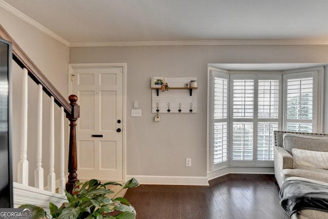 entrance foyer featuring a healthy amount of sunlight, ornamental molding, and dark hardwood / wood-style floors