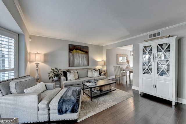 living room featuring ornamental molding and dark wood-type flooring