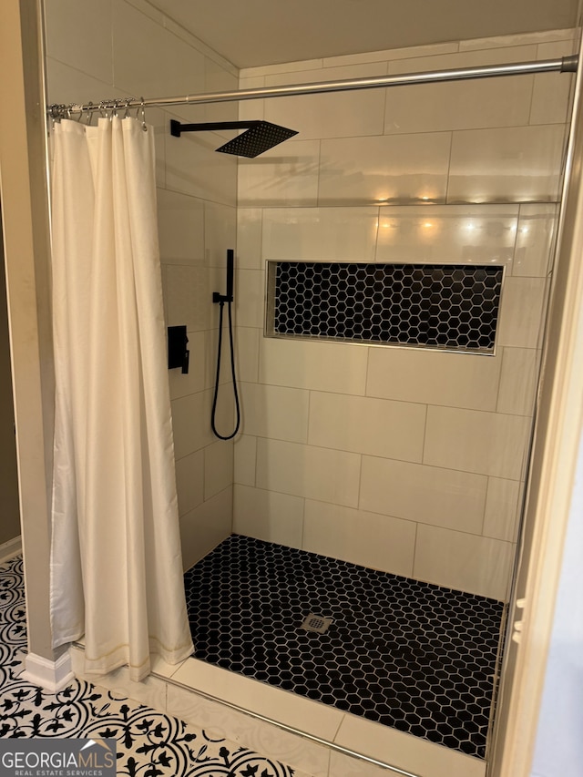 bathroom with walk in shower and tile patterned flooring