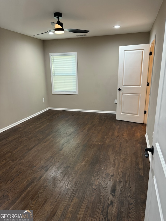 empty room featuring ceiling fan and dark hardwood / wood-style floors