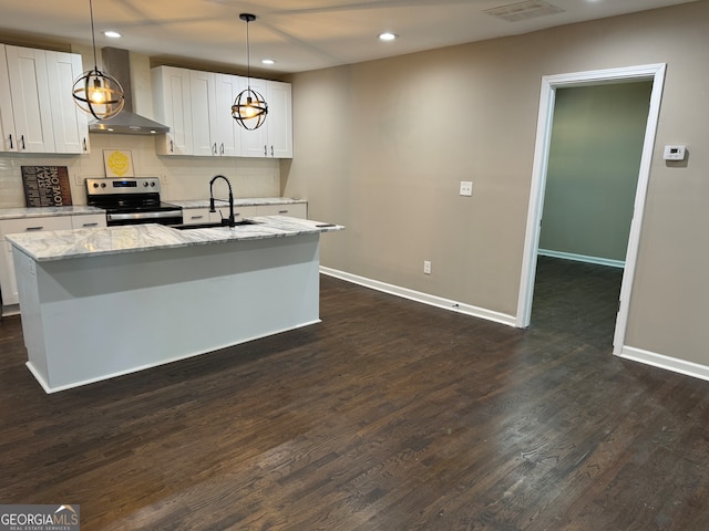 kitchen featuring white cabinets, electric range, a kitchen island with sink, wall chimney exhaust hood, and sink