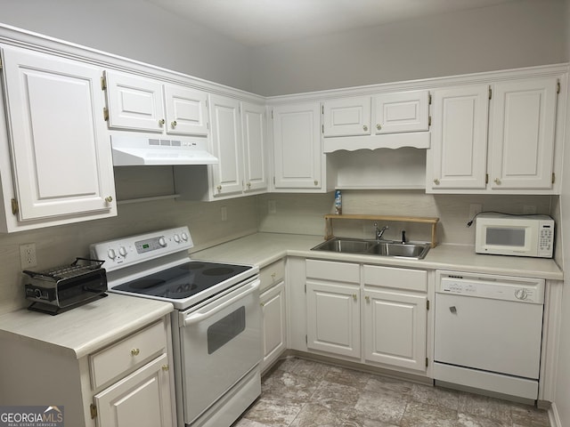 kitchen featuring sink, white cabinets, and white appliances