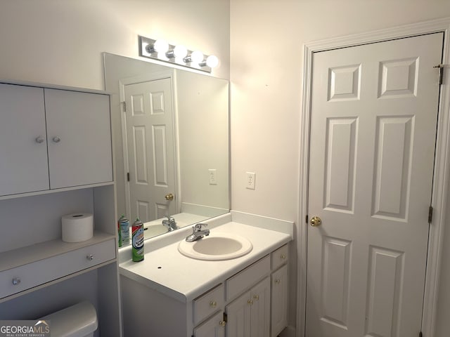 bathroom featuring vanity and toilet