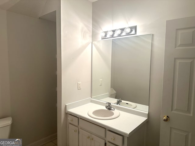 bathroom with toilet and vanity