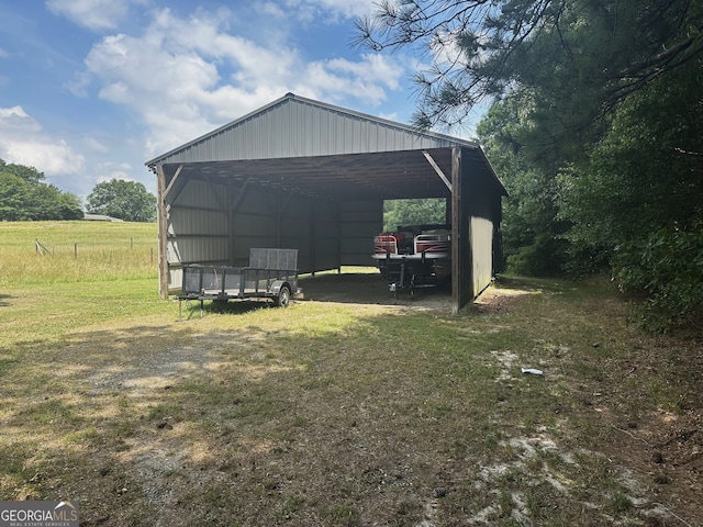 view of outbuilding featuring a lawn and a carport