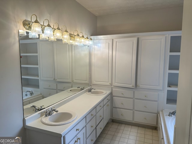 bathroom featuring vanity, a textured ceiling, and a washtub