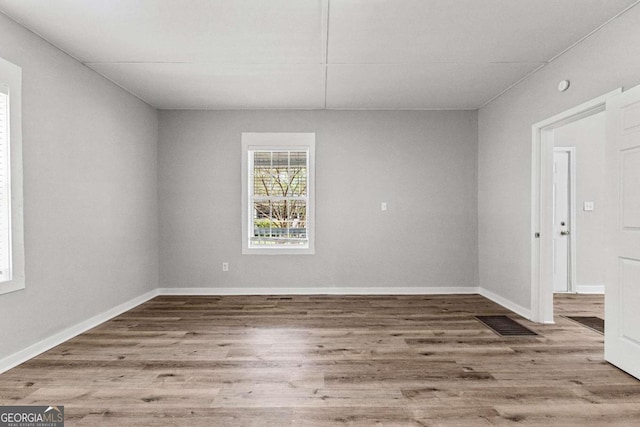 unfurnished room featuring wood-type flooring