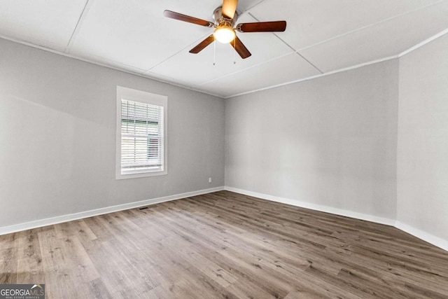 unfurnished room with ceiling fan, ornamental molding, and hardwood / wood-style floors